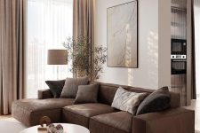 an elegant living room with a brown leather sofa, a coffee table, beige curtains, some art and a floor lamp