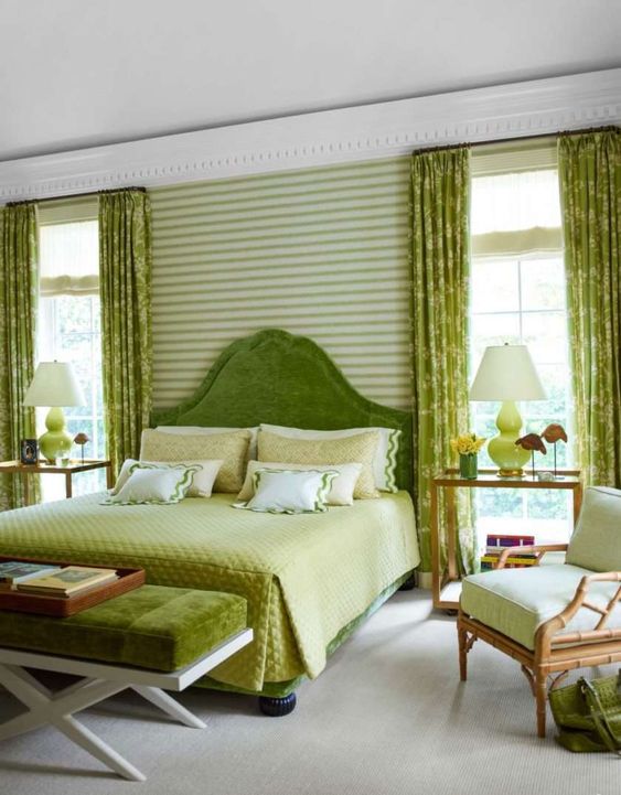 An eye catchy bedroom with a chartreuse bed and bedding, a chartreuse bench and lamps is a fun and catchy space