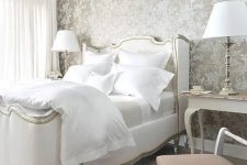 elegant grey wallpaper with a floral print, vintage white furniture and lamps for a refined and chic bedroom