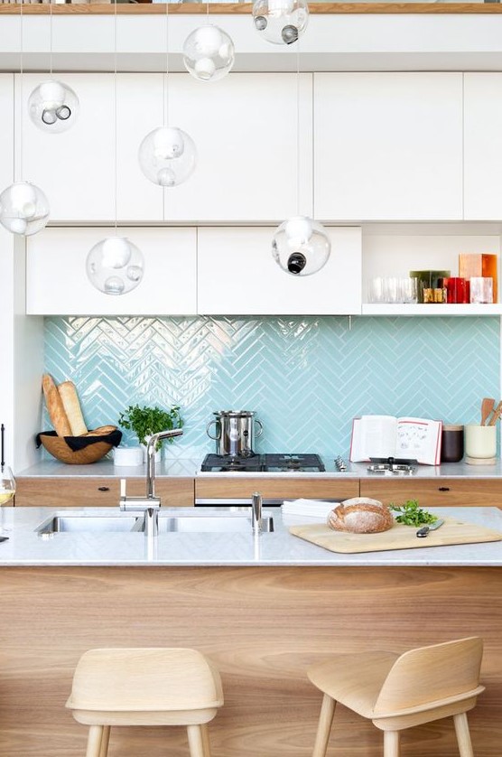 light blue herringbone tiles add a colorful touch to the neutral space