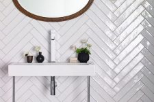 long white skinny tiles clad in a chevron pattern are a stylish idea, accent the tiles with contrasting grout