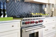 navy chevron tile backsplash stands out in a neutral farmhouse kitchen
