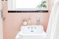 peachy pink tile with black accents is a super cool idea with plenty of contrast, it looks amazing