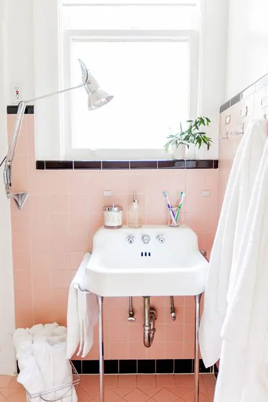 peachy pink tile with black accents is a super cool idea with plenty of contrast, it looks amazing