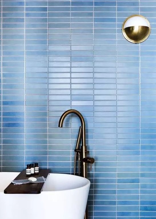 refresh your contemporary bathroom with laconic blue skinny tiles on the wall accented with white grout