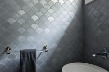 ultra-modern bathroom with gray metallic fishscale tiles and a white egg-shaped free-standing sink