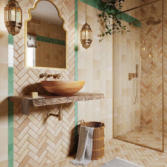 a Mediterranean bathroom done with Zellige tile, a vanity, a wink, beautiful Moroccan pendant lamps and greenery