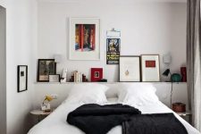 a catchy and contrasting bedroom with a ledge with artwork and books, a bed with contrasting bedding, nightstands and a black lamp
