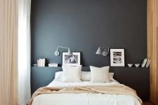 a lovely bedroom with a dramatic black wall