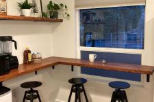 a corner countertop installed at the window, black metal stools and some decor to create a lovely breakfast bar or coffee spot