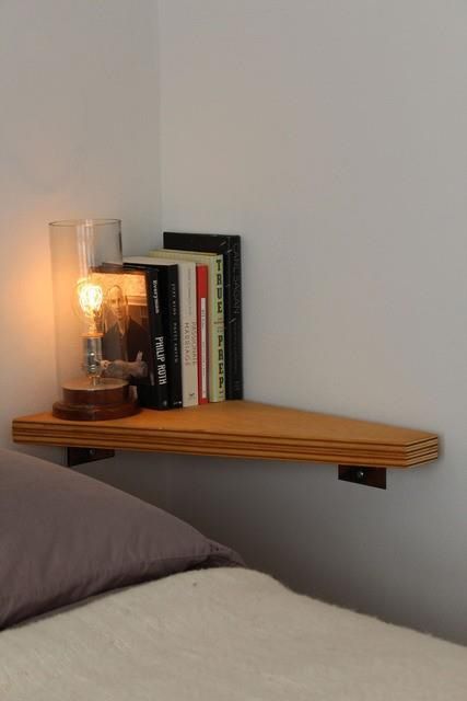 a corner shelf as a floating nightstand for a very small bedroom is a genius idea to realize, it looks cool and is easy to make