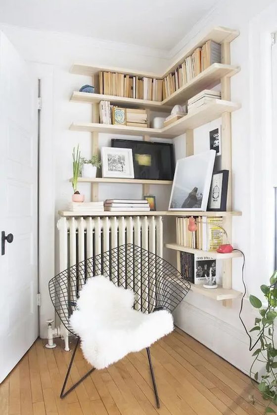 a cozy reading nook with a comfy chair and bookshelves over the radiator is a warm and cozy space