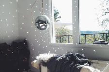 a disco ball hanging next to the window guarantees some fun and light even in the daytime