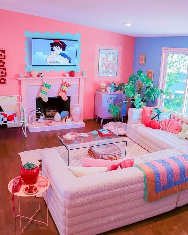 a dopamine decor living room with a bold pink and periwinkle accent wall, a fireplace, a sectional, colorful pillows and blankets and bold decor