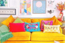 a dopamine living room with a sunny yellow sofa and colorful pillows, a printed rug and a bold gallery wall