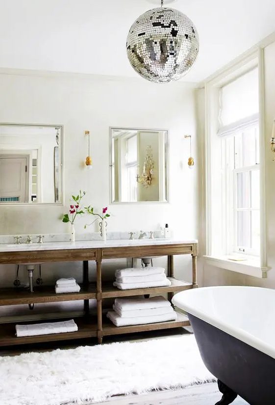 a farmhouse bathroom with a large disco ball that brings a party feel, some lights and fun to the space