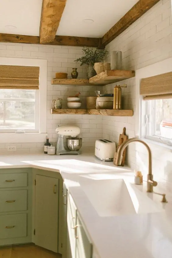 a farmhouse kitchen with stained wooden beams and matcihng corner shelves, with tableware and greenery is lovely