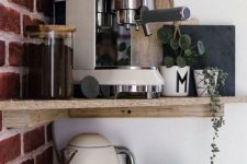 a home coffee station organized on corner shelves, with a coffee maker, a kettle, mugs and greenery is a smart idea