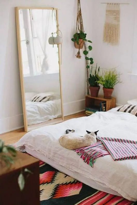 a mirror in a light-colored wooden frame for a boho-chic bedroom, and you can also place it in your closet
