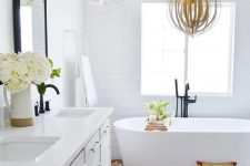 a cozy bathroom with a whitewashed vanity