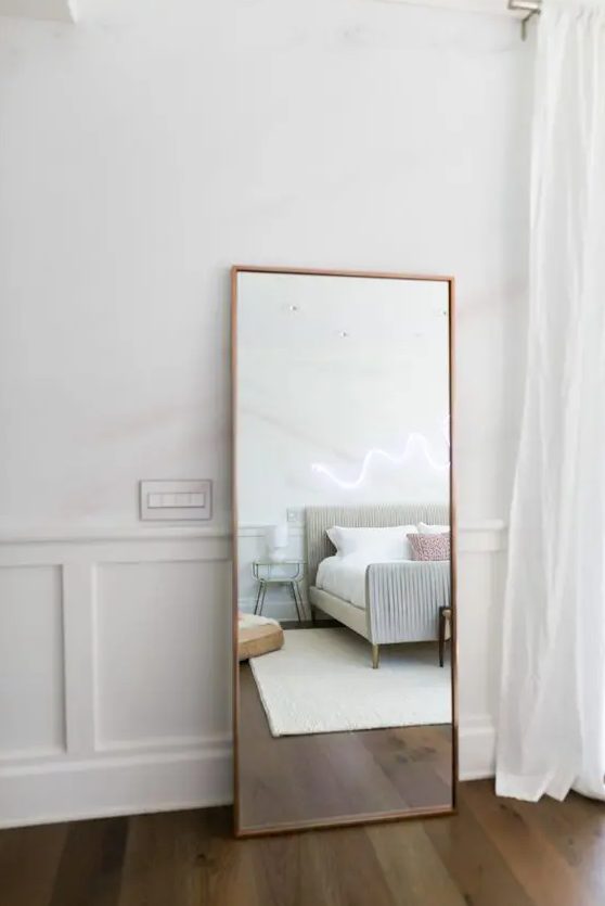 a modern mirror in a copper frame is always a fit for a modern bedroom