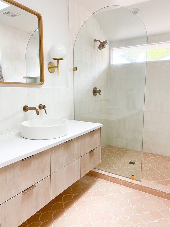 a modern neutral bathroom clad with white Zellgie and scallop terracotta tile, a stained vanity, a shower space and a mirror