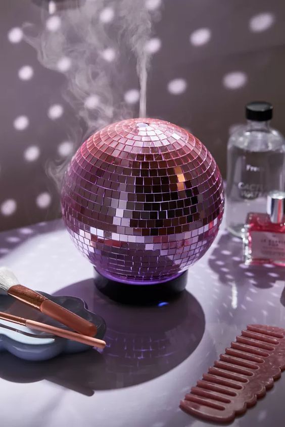 a pink disco ball aroma oil diffuser is a cool decoration for a modern space and it will be your dopamine decor piece
