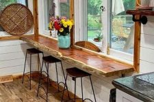 a rustic living edge windowsill and wooden stools are a cool eating zone for a small rustic or farmhouse kitchen