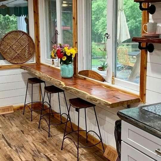 a rustic living edge windowsill and wooden stools are a cool eating zone for a small rustic or farmhouse kitchen