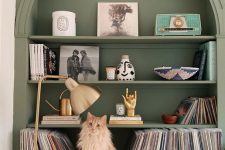 a sage green arched bookcase with a cabinet, beautiful decor and some vinyl is a chic and cool idea