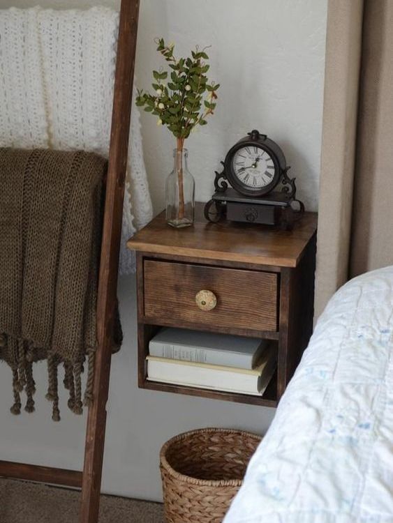 A small dark stained floating nightstand with a vintage knob is a chic and elegant solution for a tiny bedroom
