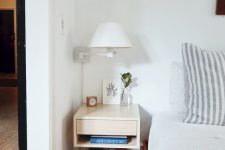 a small floating nightstand with a niche and a single drawer is a cool idea for most small bedrooms, it works and features storage