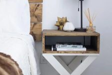 a small nightstand with criss cross legs and a stained shelf is a cool idea for a rustic bedroom