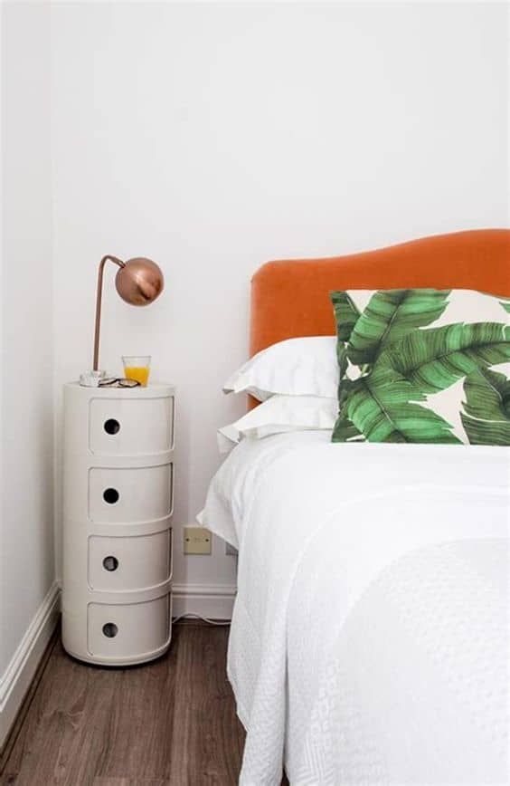 a small rounded nightstand with several storage compartments is a cool and quirky solution for a modern small bedroom