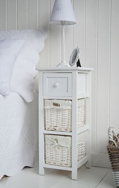 a small white coastal nightstand wih a drawer and baskets is a lovely idea for a vintage coastal home