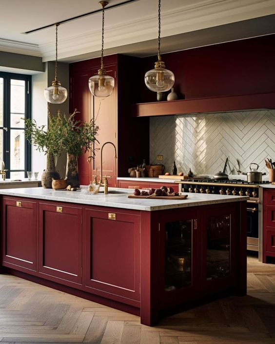 a sophisticated burgundy kitchen with a white herringbone tile backsplash and a matching kitchen island with storage space