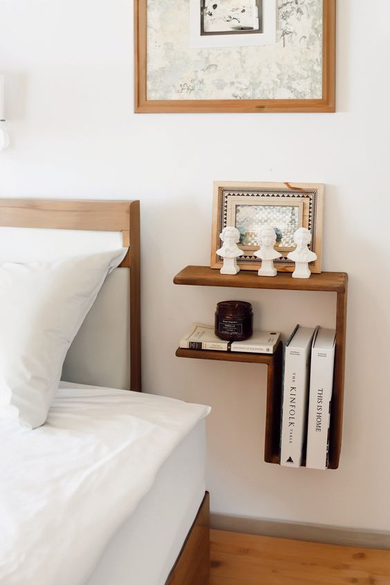 A stylish dark stained wall mounted nightstand is great for storage and styling a space, it looks cool
