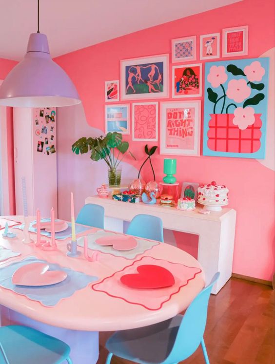 a super bold dopamine decor dining room with hot pink walls, white tables and blue chairs, a lilac pendant lamp, a bright gallery wall and bold decor