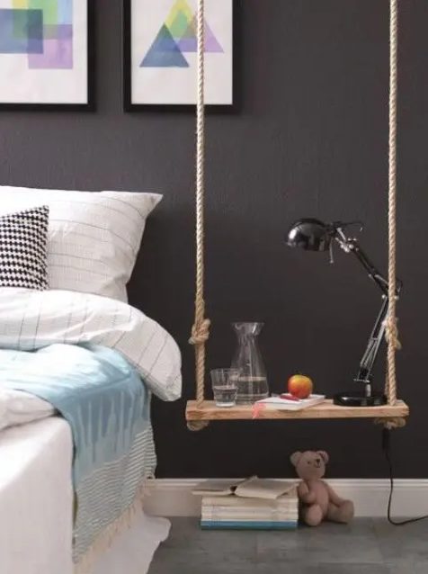 a swing as a bedside table is a creative idea and a way to add a fun touch to an adult space