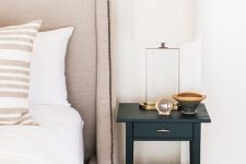a tiny black nightstand with a drawer and a gold handle is a cool idea for a modern bedroom and a touch of color