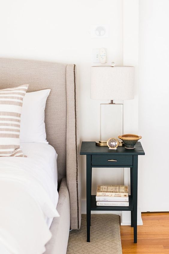 a tiny black nightstand with a drawer and a gold handle is a cool idea for a modern bedroom and a touch of color