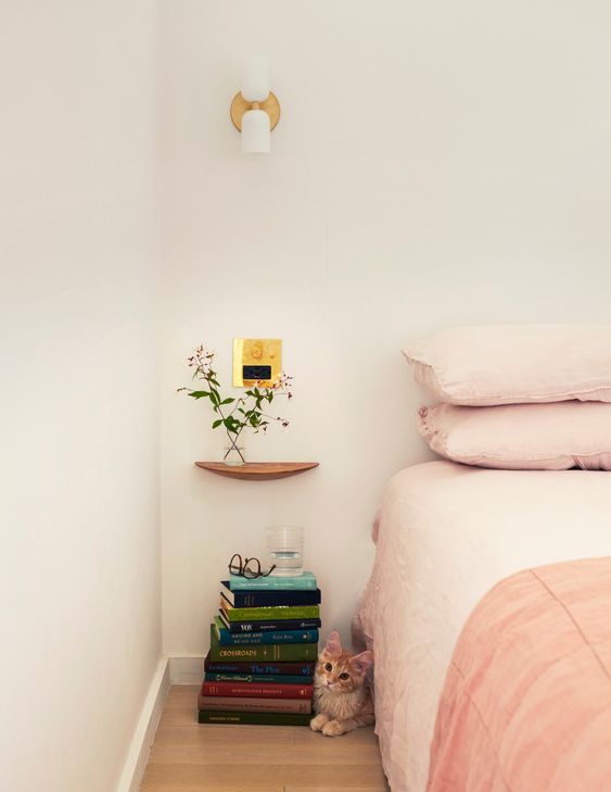 a tiny floating nightstand, which is a rounded shelf that can't hold a lot, maybe just some blooms