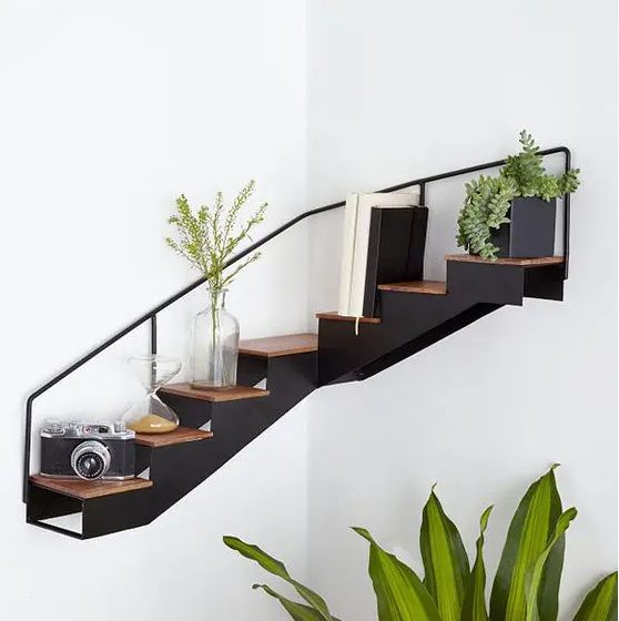 a very creative staircase corner shelf allows you to store and display a lot of stuff and looks awesome