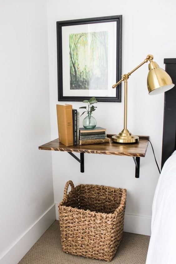 A wall mounted shelf of stained wood is a cool solution for a farmhouse space and a basket adds coziness to the nook
