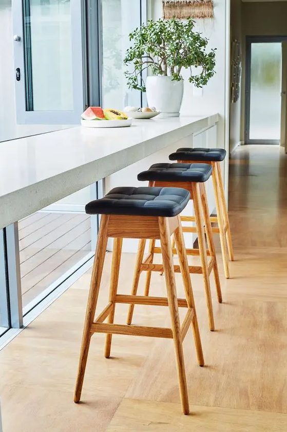 a windosill breakfast bar, tall stools with leather seats and potted plants will allow you enjoy a cool view and natural light