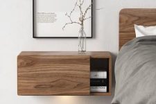 a wooden floating nightstand with a sliding door for comfy storage in a minimalist or Scandi space