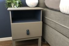 an IKEA Tarva nighstand painted grey and with a black leather pull is a simple makeover with plenty of style