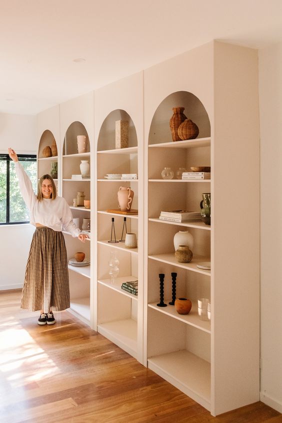 an arched wall library like this one will bring a trendy touch to any space, build your own one