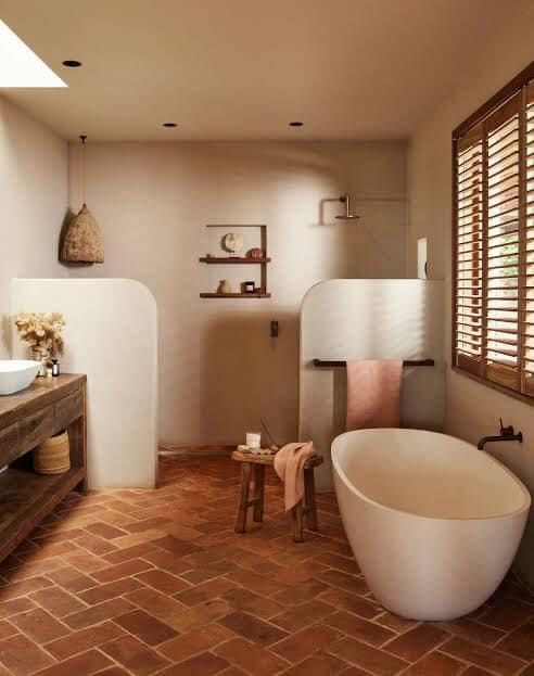 an earthy bathroom with a large shower space, a tub, a terracotta tile floor, a large rough wood vanity and a pendant lamp
