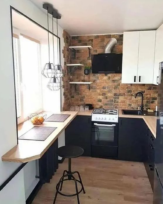 an industrial kitchen with black and white cabinets, a brick backsplash, a windowsill breakfast bar, a stool and pendant lamps